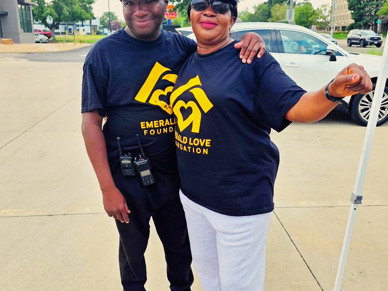Volunteers sharing smiles in Emerald Love Foundation gear